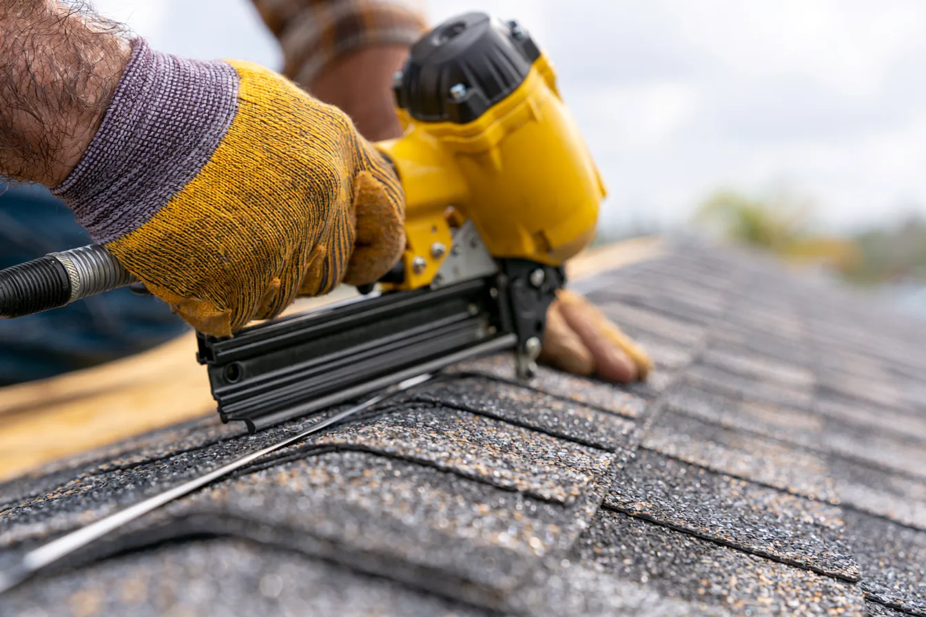 New cap shingles going on along a ridge line